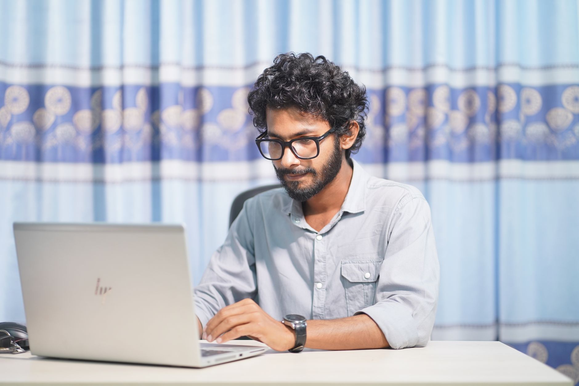 A web developer working on a client site in a small studio