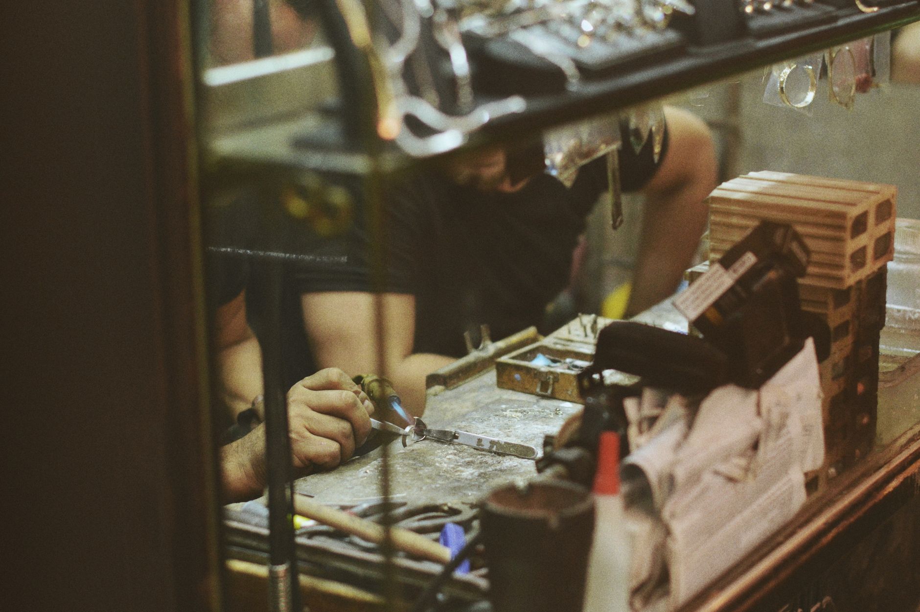 A craftsperson working carefully on a handmade piece