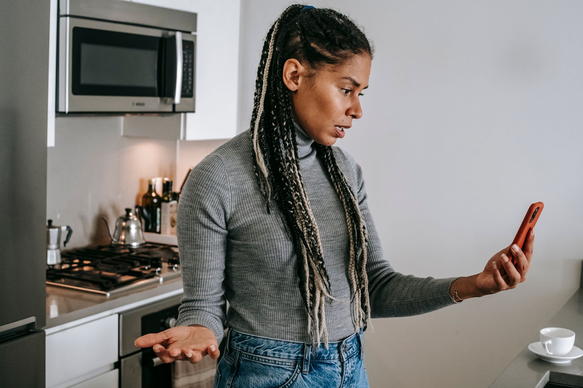 A homeowner looking unimpressed while speaking with a tradesperson
