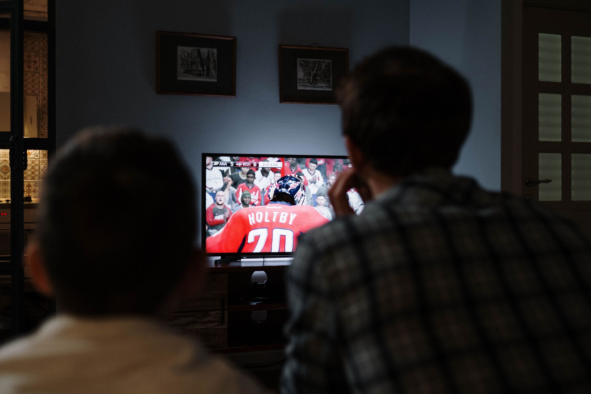 A UK family watching video content together on the television in the evening